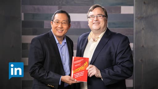 Chris Yeh and Reid Hoffman holding the Blitzscaling book