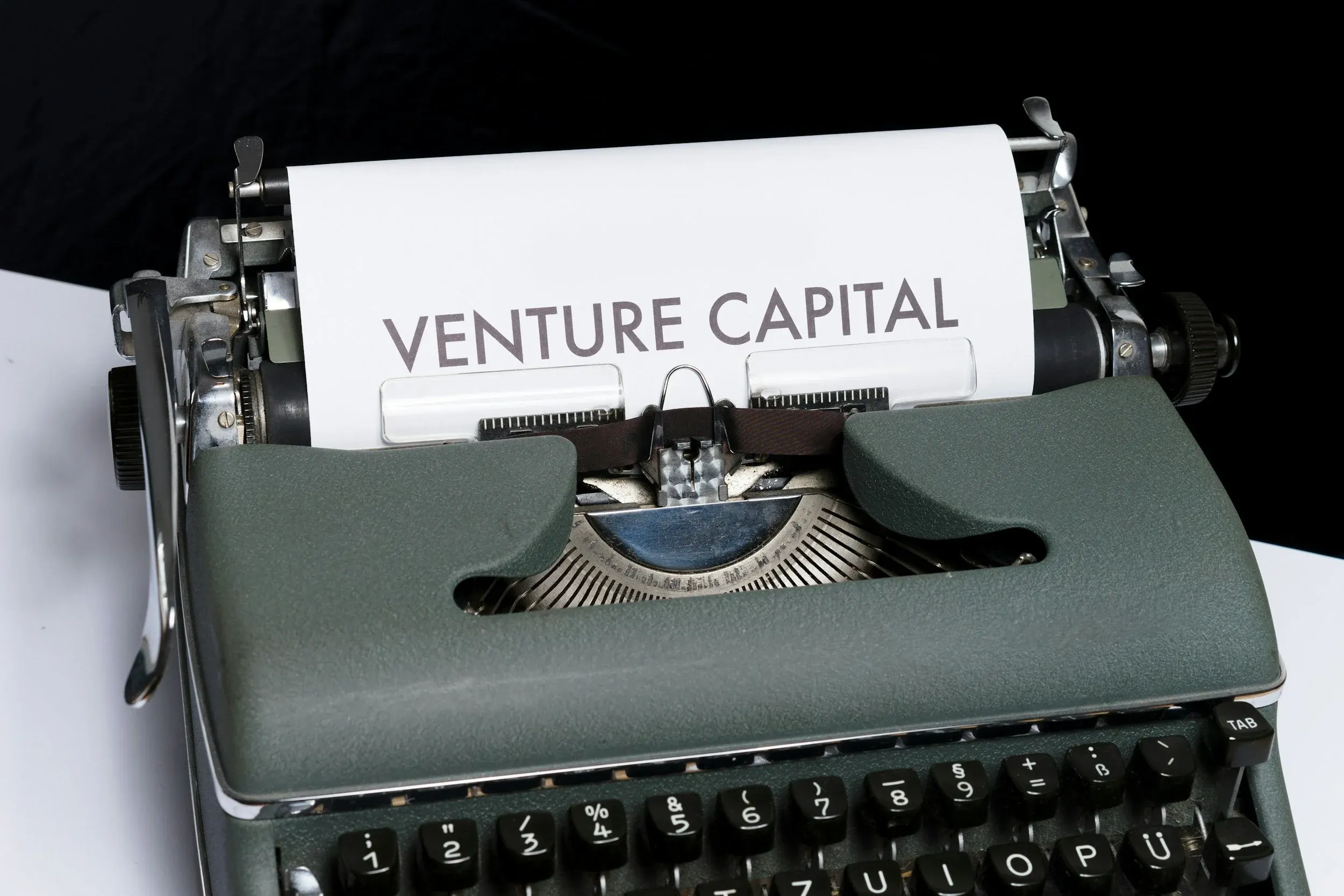 Typewriter with 'VENTURE CAPITAL' text, startup fundraising and equity dilution