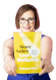 Frances Pratt holding her book More Sales Less Marketing