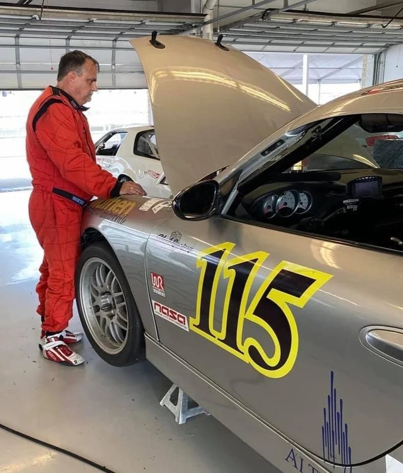 John Lionberger preparing his race car, #115