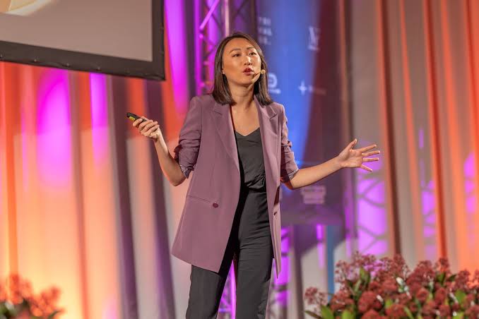 Sharon Gai keynote speaking at a large conference